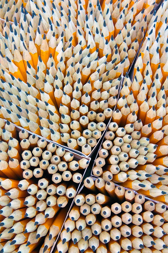 brand-01 Close-up of sharpened wooden pencils organized in a geometric pattern.